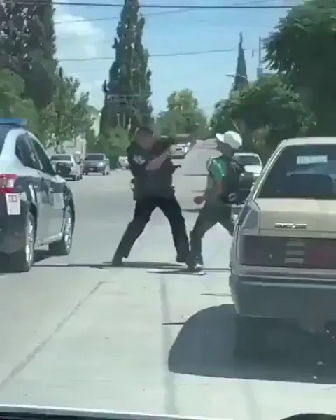 Man throws hands with a police officer