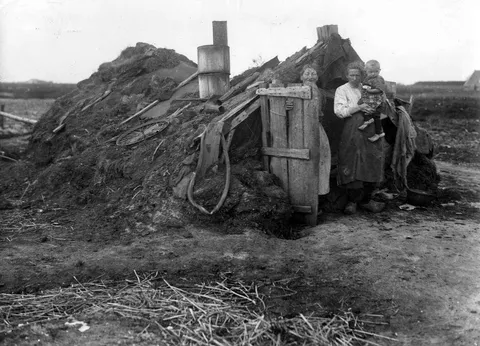 Occupants of a sod house in Drenthe, the Netherlands, photographed standing outside in 1936.