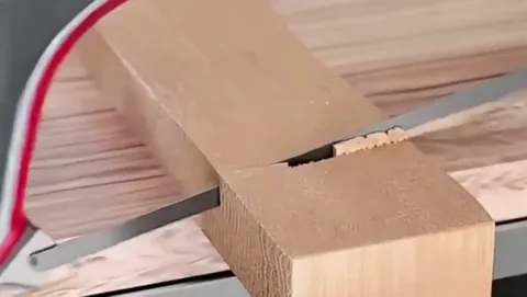 sawing a piece of wood