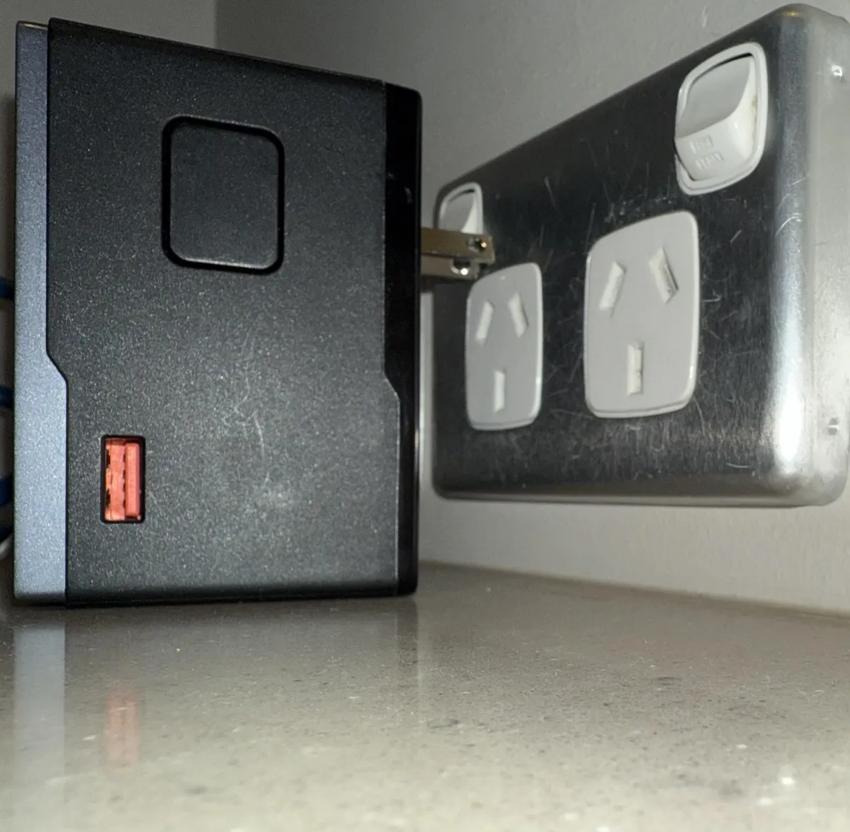 The only power outlet in my hotel room and my power supply…