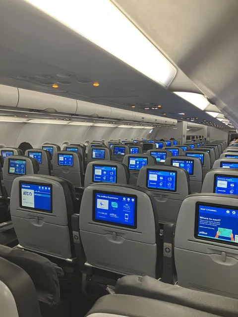 Forced to stay in assigned seat on a red eye despite all these open rows.