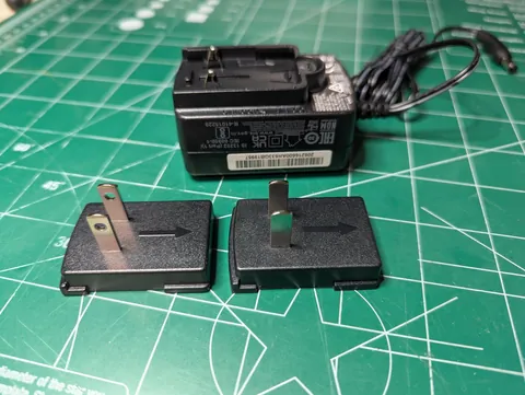 This Seagate power adapter come with 2 US style plugs: one with holes and one without