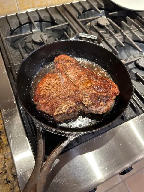 [homemade] 30oz porterhouse steak with onion rings and corn on the cobb.