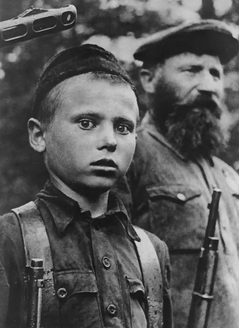 A child serving in the Soviet partisans. Photographed 1942, Novgorod.