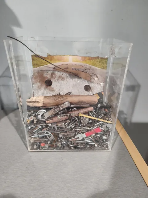 Box of stuff pulled from tires at a tire place waiting room