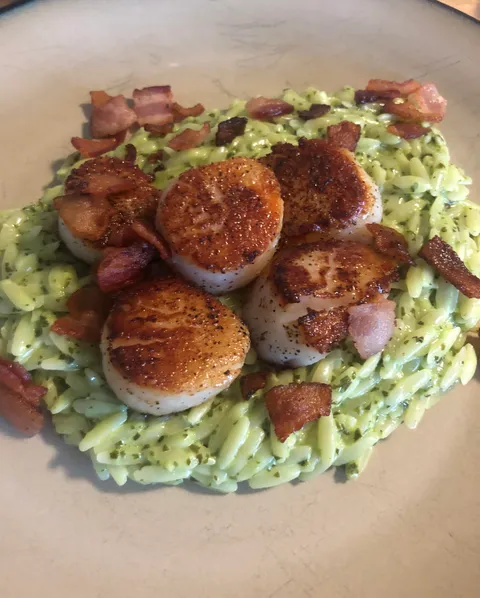 Seared scallops over creamy basil pesto orzo with bacon (of course).