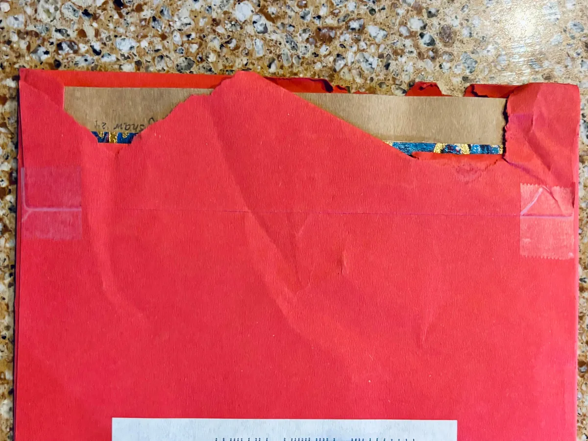 How the US Postal Service delivers a card that a postal worker tore open to steal a gift card