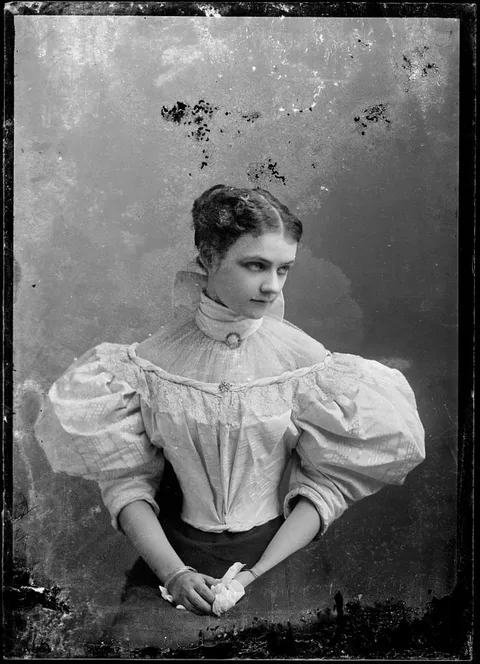 Young woman with puffy sleeves giving a heck of a sideways look, circa 1890s. glass negative.