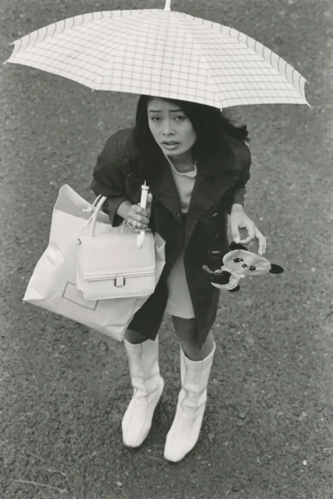 In 1974, Masahisa Fukase photographed his wife, Yōko Wanibe, every morning from the window of their apartment in Tokyo as she left for work.
