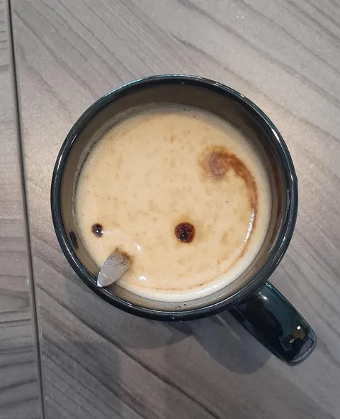 My coffee looks like a balding man with a pointy nose