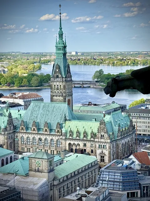 Hamburg town hall being watched over by a gargoyle from 1875’s world’s tallest building.