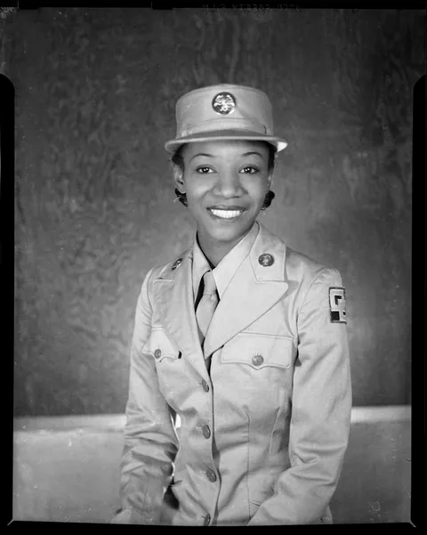 WAAC lady gives a bright smile on her uniform, circa 1940s.