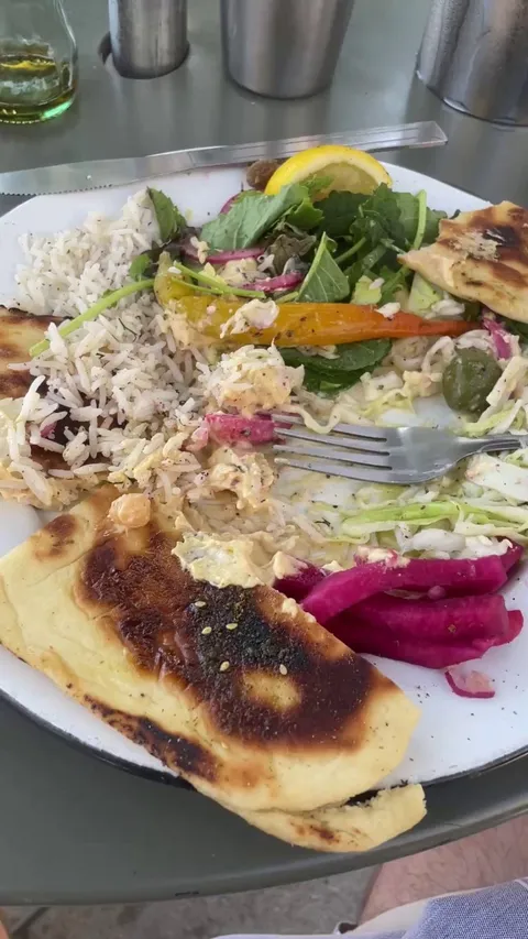 Friction between plate and table is lower than friction between fork and food.