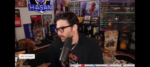 Hasan reaches over and suddenly Kaya, his dog, repositions in her bed after he looks to his second monitor. (clip of before the incident)