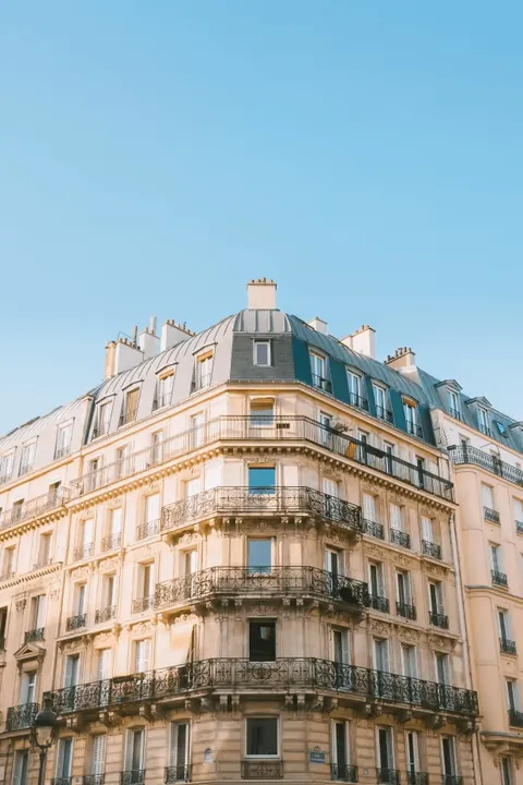 Why don't a lot of New York residential apartments have balconies while most Parisian buildings do?