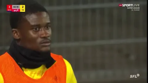 Chris Bedia of Young Boys vibing with the choir of opposition fans before realising that the camera is on him.