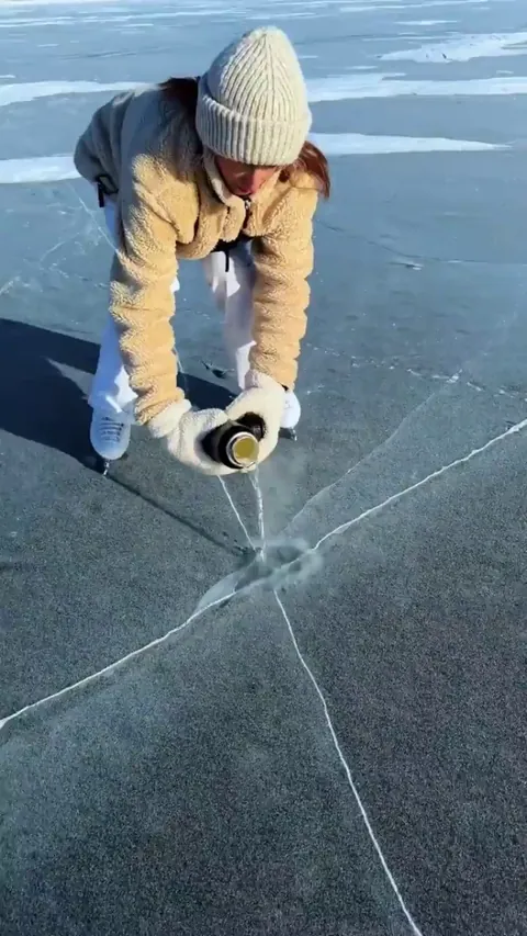 Pouring hot water on cracks in the ice