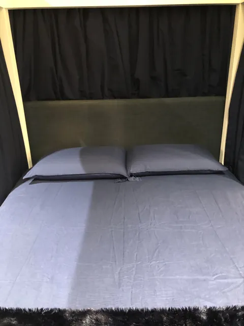 My new four-poster bed with curtains that actually close.