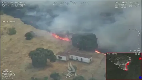 Firefighting Plane Drops Water Seconds Before Flames Reach Home