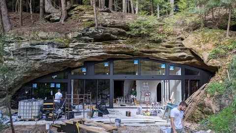 Is building under a huge rock like this safe? My first thought when I say this was earthquakes.
