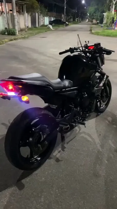 Showing off his pretty motorcycle in Brazil