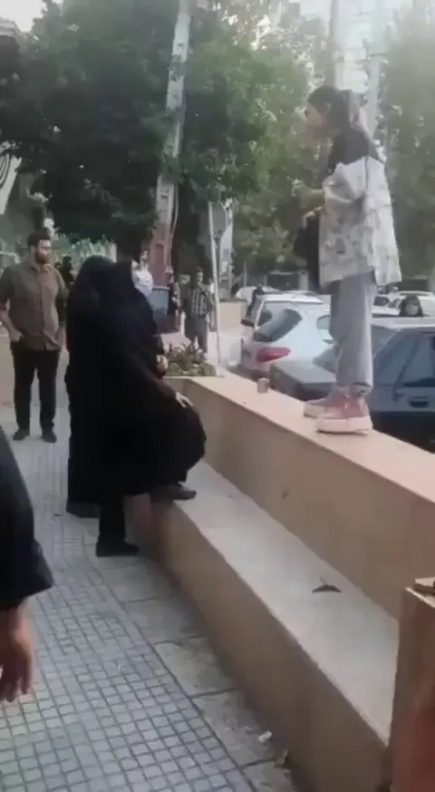 Brave Iranian girl has removed her Hijab and is standing in confrontation with the morality police “You can not take me away”