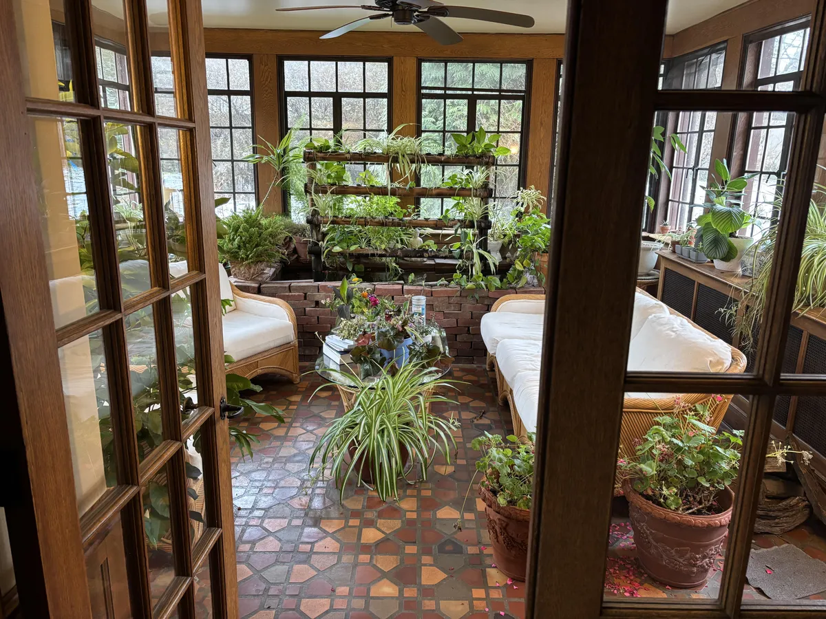 Sunroom for all seasons with koi pond and aquaponic plants system