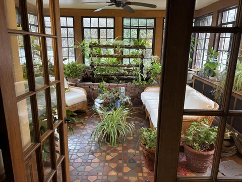 Sunroom for all seasons with koi pond and aquaponic plants system