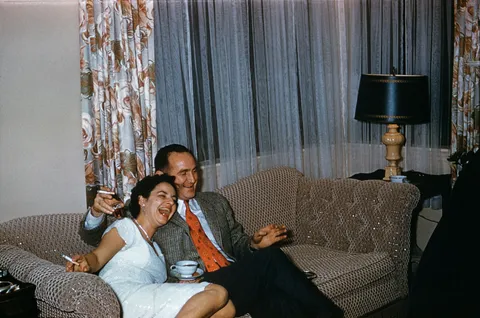 Couple laughing at something lost to time. circa mid 1950s