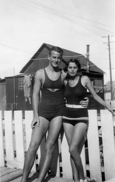 John Wayne with his girlfriend Josephine at the beach in Southern California, circa 1920s.