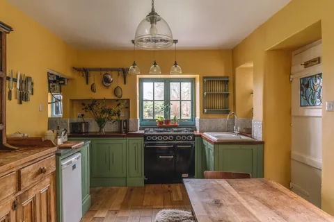 Country kitchen with warm colors in a 19th-century cottage, village of Brigsteer, Lake District, Cumbria, England [1600x1067]