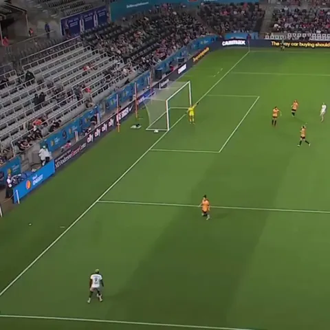 Racheal Kundananji stands on the ball and beckons towards Paige Nielsen before dribbling past her