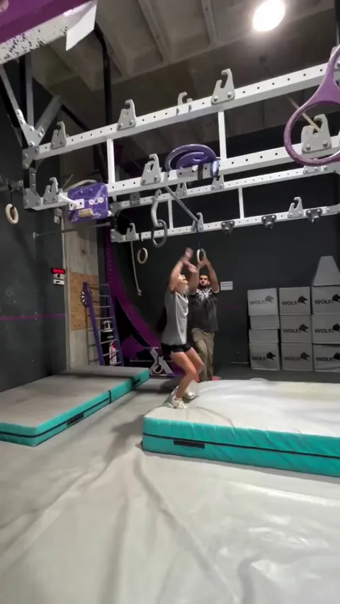 A girl practices a 4.5m/14.7ft lache on the bar.