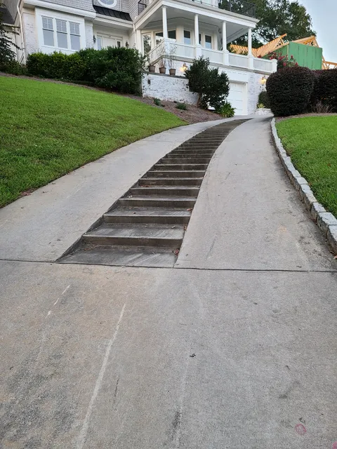 An inclined driveway that has stairs.