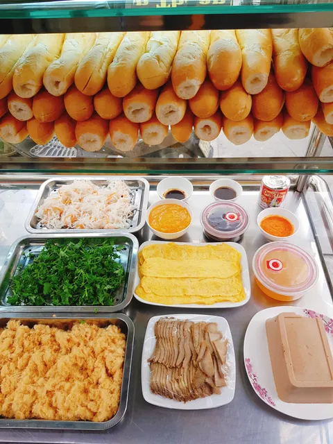 My mom's little banh mi shop. Almost every topping is made by my parents, we're in Ha Long Bay, wish to see Reddit-er one day ❤