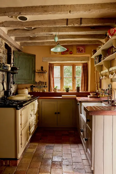 Farmhouse-style kitchen with exposed stone walls in a cottage that dates from the 15th century, village of Loose, Maidstone, Kent, England [712x1067]