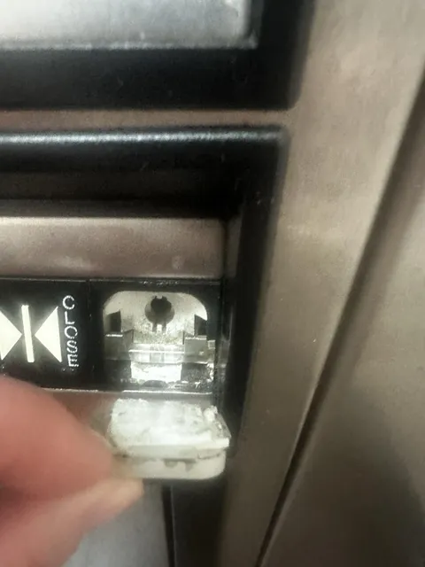 Hit the Close Door button in an elevator and it fell off, showing no wiring and stuck on with double-stick tape.
