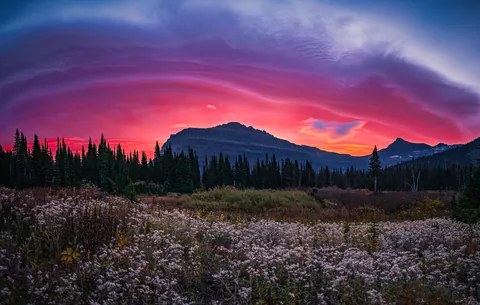 One of the wildest sunrises I've witnessed to date; Gnarly lenticulars burning over Citadel Mountain in Glacier National Park, MT. [2250x1429][OC@madisonkoboldphotography]
