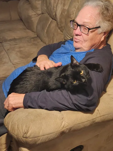 After almost two YEARS, my sweet but very anxious kitty Chompy snuggled up into my dad's arms for the first time ever.