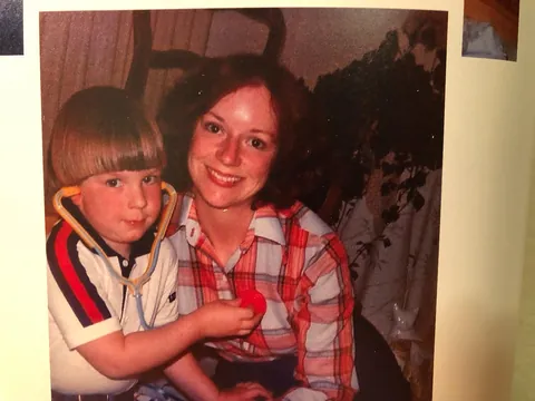 Me, four years old, listening to the heartbeat of my gorgeous mother with a toy stethoscope in our matchbox of a living room, Merced, California, May 1979.