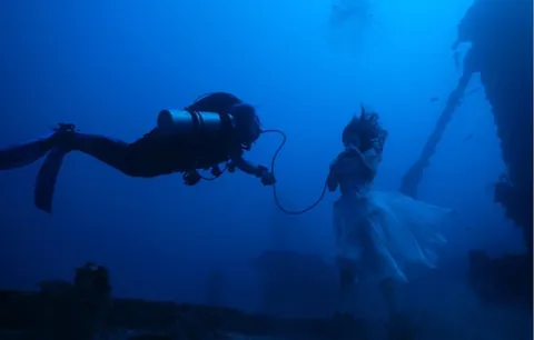 Canadian photographer Steven Haining breaks world record for deepest underwater photoshoot at 163ft - model poses on shipwreck WITHOUT diving gear