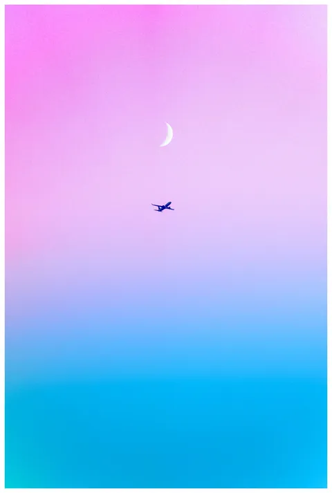 ITAP of a plane crossing under the moon during sunset.