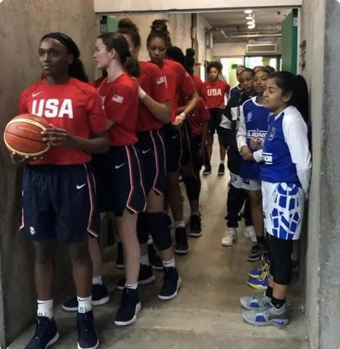 Team USA’s U16 women’s basketball standing next to El Salvador’s U16 team. The score was 114 to 19