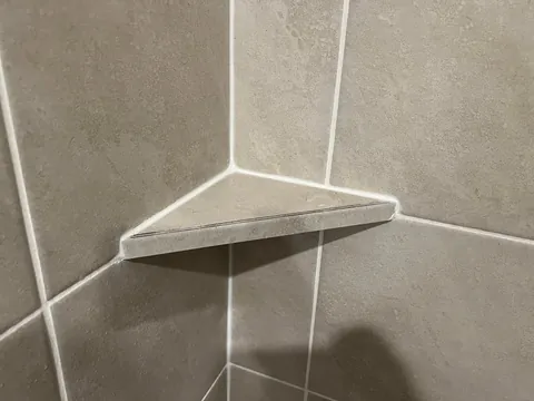 How is this shower shelf made from tile secured?