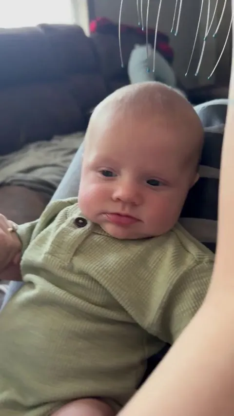 A baby’s gentle head massage and the pure joy on his face
