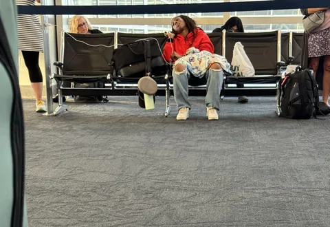 This person taking up a whole row of seats at our gate.