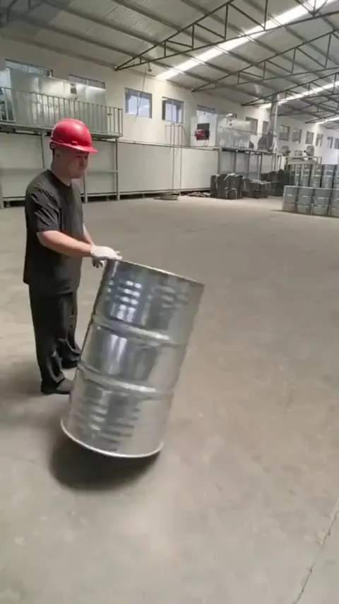 Warehouse worker rolls barrels to perfection