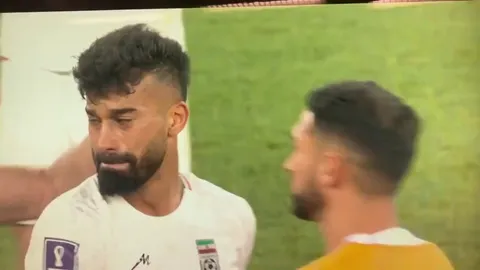 Antonee Robinson embraces the distraught Ramin Rezaeian at full time. USA vs Iran.