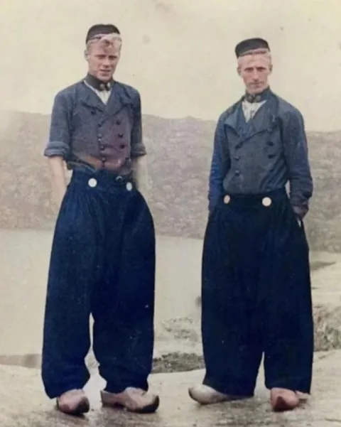Two Harbor Workers In Their Traditional Klepbroek In Voldendam, Netherlands (1904)