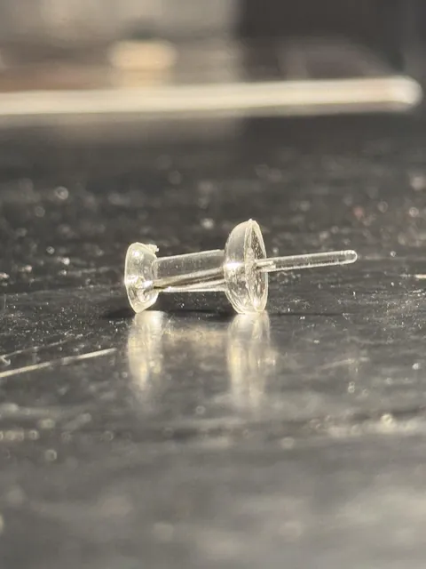 This thumbtack that is accidentally plastic instead of metal